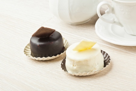 chocolate pastry little cake with tea cup on  wooden tableの写真素材