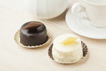 chocolate pastry little cake with tea cup on  wooden tableの写真素材