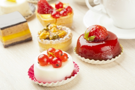 Different sort of beautiful pastry, small colorful sweet cakesの写真素材