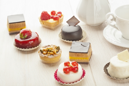 Different sort of beautiful pastry, small colorful sweet cakesの写真素材
