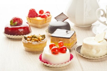 Different sort of beautiful pastry, small colorful sweet cakesの写真素材