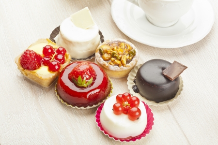 Different sort of beautiful pastry, small colorful sweet cakesの写真素材
