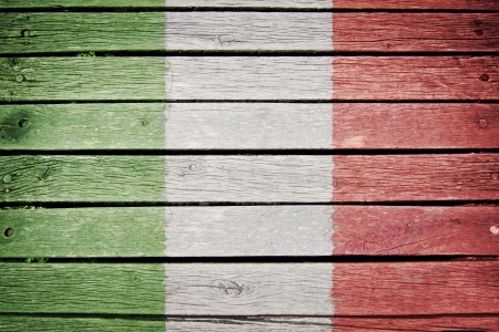 italian flag painted on old wood plank backgroundの写真素材