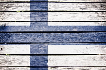 finland, finnish flag painted on old wood plank backgroundの写真素材