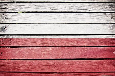 poland, polish flag painted on old wood plank backgroundの写真素材