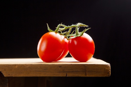 fresh ripe cherry tomato on wooden tableの写真素材