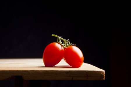 fresh ripe cherry tomato on wooden tableの写真素材
