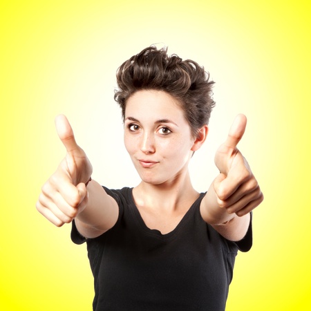 Happy smiling girl with thumbs up gesture, isolated on white backgroundの写真素材