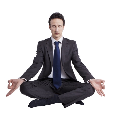young businessman meditating in yoga lotus pose on white backgroundの写真素材