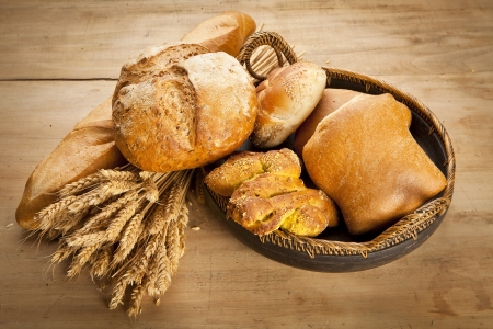assortment of fresh baked bread on wood tableの写真素材