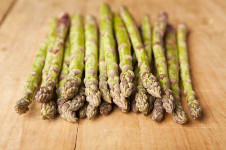 Bunch of fresh green asparagus on wooden backgroundの写真素材