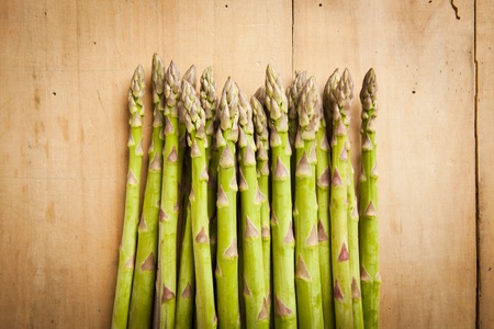 Bunch of fresh green asparagus on wooden backgroundの写真素材