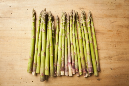 Bunch of fresh green asparagus on wooden backgroundの写真素材