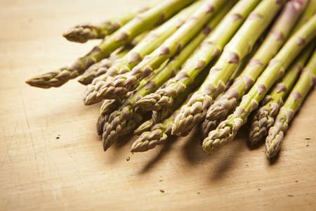 Bunch of fresh green asparagus on wooden backgroundの写真素材