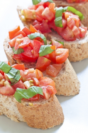 Crostini with tomato, oil, basil and garlicの写真素材