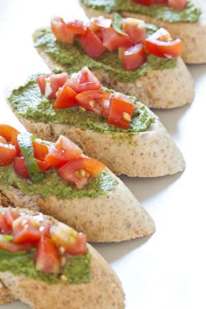 Crostini with arugula cream and tomatoesの写真素材