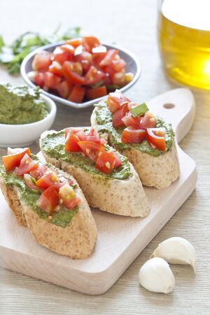 Crostini with arugula cream and tomatoesの写真素材