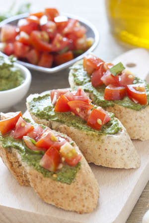 Crostini with arugula cream and tomatoesの写真素材