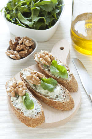 Crostini with gorgonzola cheese, arugula and walnutの写真素材