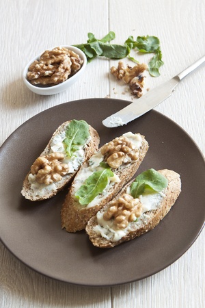 Crostini with gorgonzola cheese, arugula and walnutの写真素材
