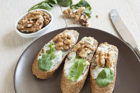 Crostini with gorgonzola cheese, arugula and walnutの写真素材