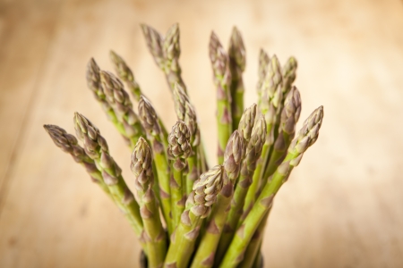 Bunch of fresh green asparagus on wooden backgroundの写真素材