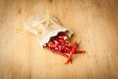 Red hot dry chili peppers on wooden backgroundの写真素材