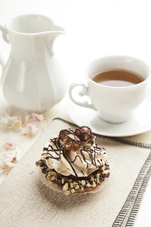 Closeup muffin with vanilla cream and hazelnutsの写真素材