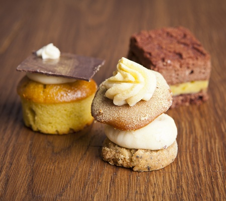 delicious cupcake pastry on wooden background tableの写真素材