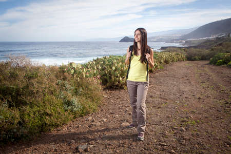 young woman hiking in the nature near the oceanの写真素材