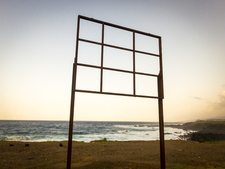 empty billboard near the sea at sunsetの写真素材