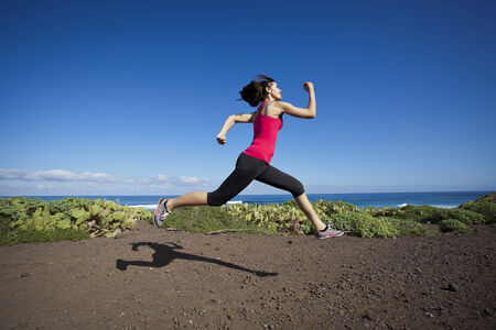 atlhlete woman running in nature. Healthy active lifestyle young woman exercising outdoors.の写真素材
