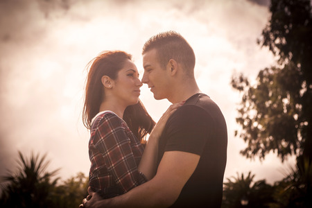happy young couple in love kissing outdoorの写真素材
