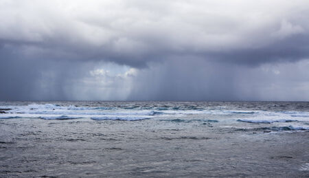 stormy weather on the ocean, rain over the seaの写真素材