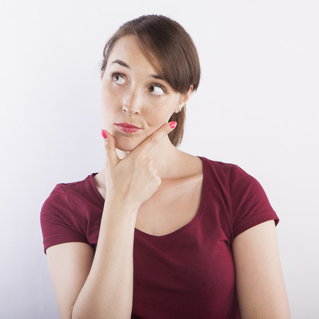 young beautiful woman thinking, pensive face expressionの写真素材