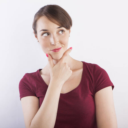 young beautiful woman thinking, pensive face expressionの写真素材