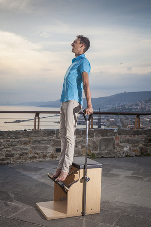 Pilates personal trainer doing class on a machine  outdoorsの写真素材