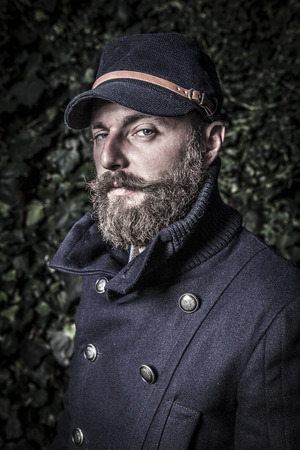 portrait of a stylish man with beard, hipster sailor styleの写真素材