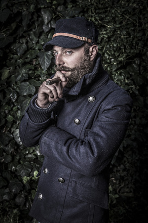portrait of a stylish man with beard, hipster sailor styleの写真素材