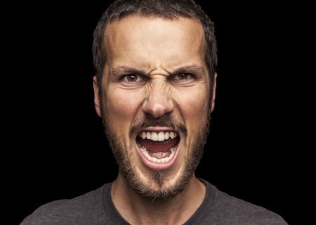 portrait of a young beautiful man screaming