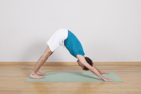 man practicing pilates indoor, return to life sequence, 34 exerciseの写真素材