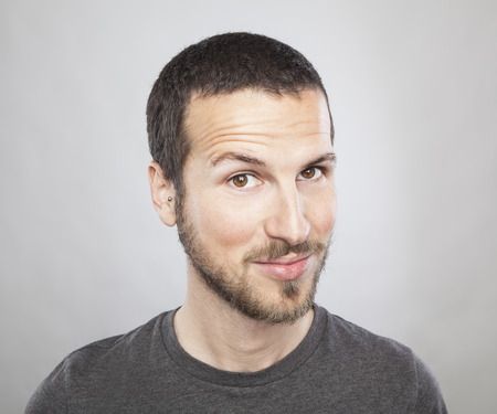 portrait of a young beautiful man smiling, face expressionの写真素材