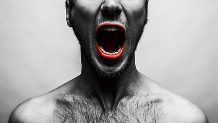 close up portrait of a man shouting, mouth wide openの写真素材
