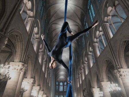 beautiful woman dancing with aerial silk in a cathedral interiorの写真素材