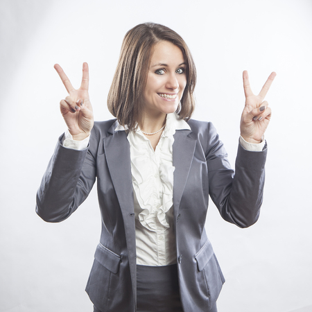 beautiful young businesswoman portrait, victory signの写真素材