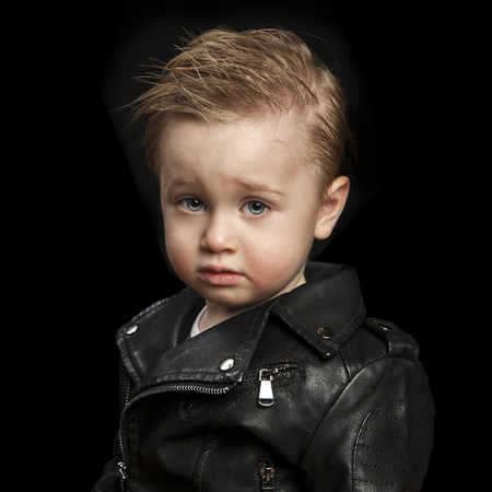 portrait of adorable young boy in leather jacket