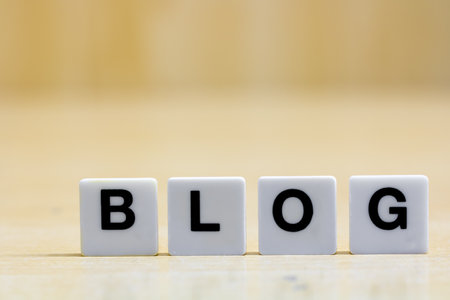 A row of tiles forming the word blog. A row of small white plastic tiles, containing the letters...