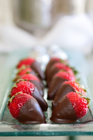 Two rows of strawberries covered in chocolateの写真素材