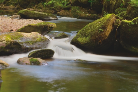 Long exposure of the river flowing through rocks at Watersmeet in Devonの写真素材
