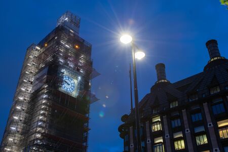 Street view of Big Ben at night covered in scaffolding